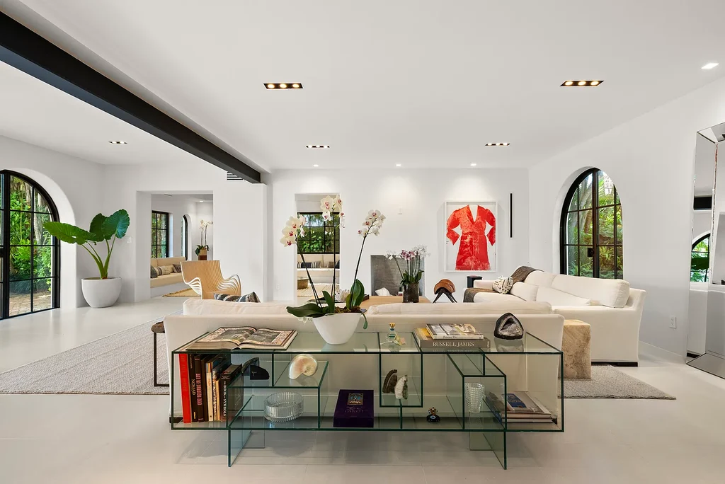 Mediterranean Revival living room with arched windows and coastal interiors at 6065 Pine Tree Dr