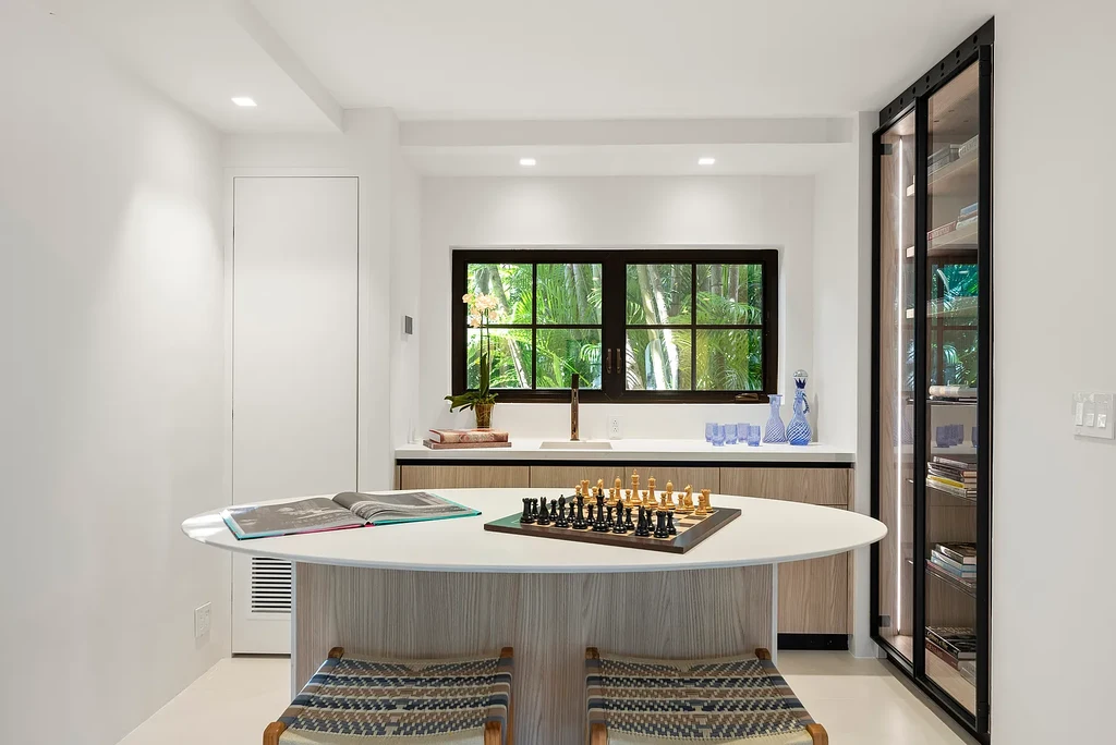 Mediterranean Revival living room with arched windows and coastal interiors at 6065 Pine Tree Dr