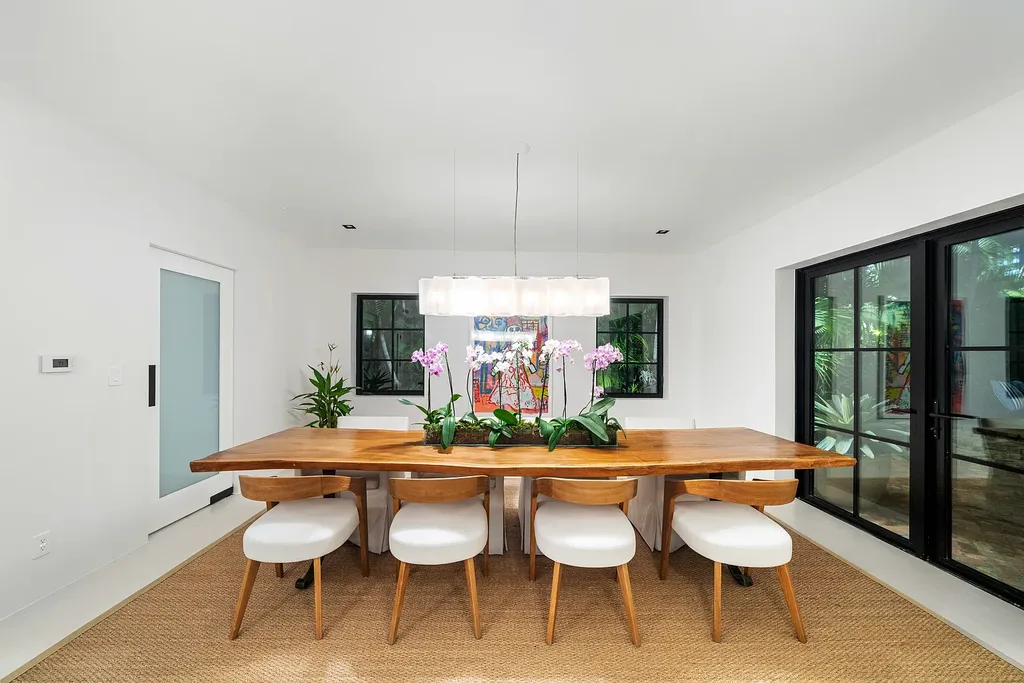 Mediterranean Revival living room with arched windows and coastal interiors at 6065 Pine Tree Dr
