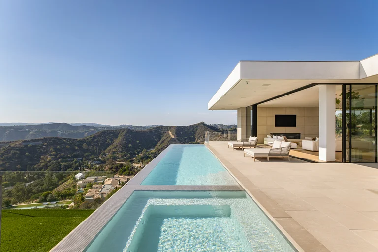 Stunning infinity pool and spa area at The View Estate, demonstrating the seamless edge spilling into the panoramic canyon and city views.