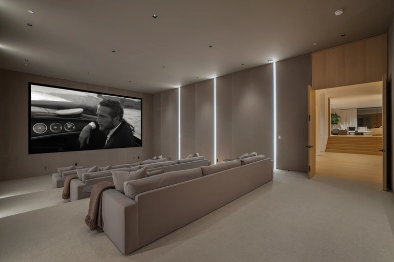 State-of-the-art home cinema room in the subterranean entertainment lounge, featuring modern lighting and oversized seating.