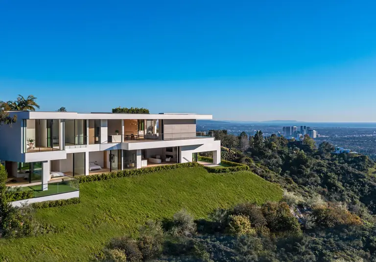 Aerial exterior view of The View Estate, the most expensive home in Beverly Hills, showing modern architecture and expansive lawn with city skyline views.