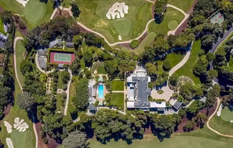 Aerial view of Casa Encantada estate showing tennis court, pool and gardens in Bel Air.