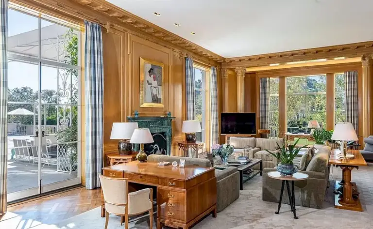 Library and sitting room with walnut paneling and fireplace at Casa Encantada Bel Air.