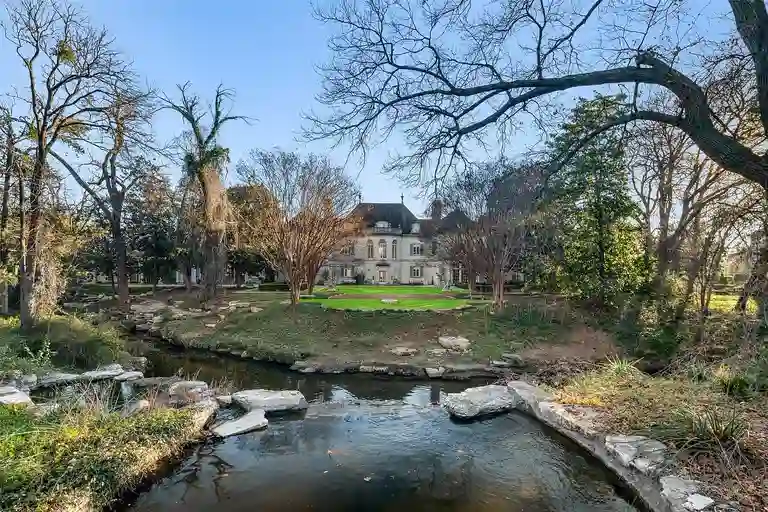 Garden creek and wooded view behind the most expensive home in Texas.