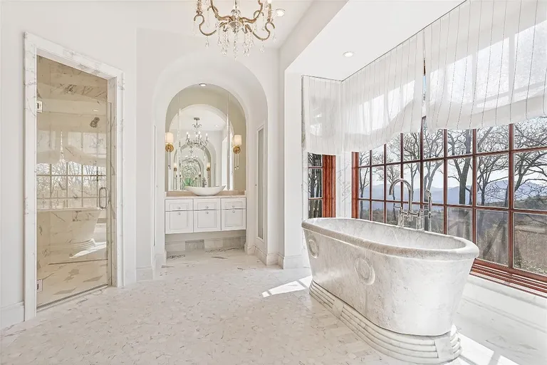 Sunlit garden room in Sagee Manor, the **most expensive house in North Carolina**, featuring an intricately painted ceiling, arched windows, and light-filled luxury seating.