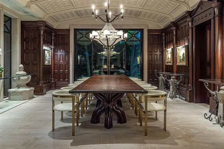 Formal dining room in The Lodge, the **most expensive home in Houston**, featuring elegant dark wood paneling, a coffered ceiling, and a long luxury dining table