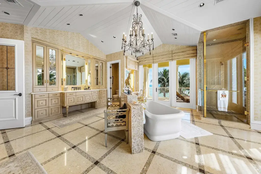 1083 Hillsboro Mile luxury ocean-to-intracoastal estate in Hillsboro Beach, FL featuring 8 bedrooms, 13 bathrooms, private beach, guest house, and expansive pool terrace