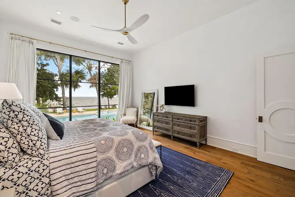 Luxury bayfront estate at 147 Ansley Forest Dr, Santa Rosa Beach, featuring private dock, pool house, 6 bedrooms, 7 bathrooms, and contemporary coastal design with panoramic water views.