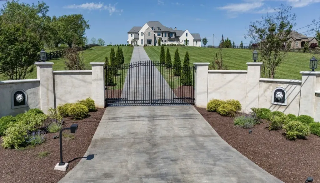 Gated entrance and tree-lined driveway leading to a modern luxury estate on 5.34 acres in Mount Juliet, Tennessee.