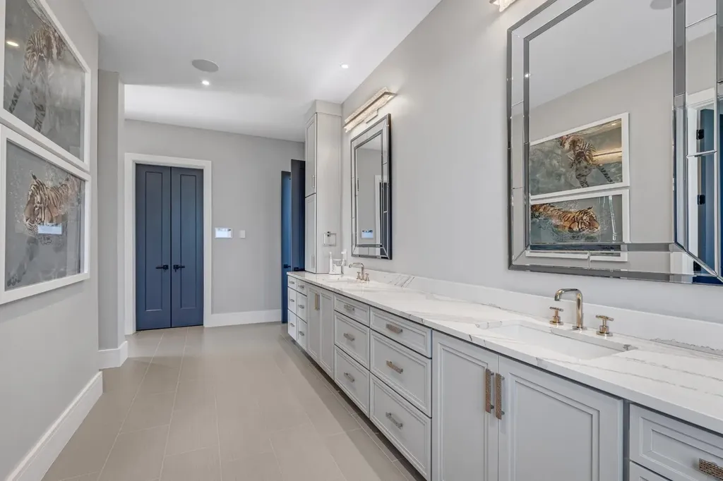 Elegant bathroom with dual marble vanities, brass fixtures, and contemporary mirrors in a luxury home in Mount Juliet, Tennessee.