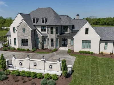 Modern French-inspired luxury estate on 5.34 acres in Mount Juliet, Tennessee, featuring a stone façade, steep rooflines, and manicured landscaping.
