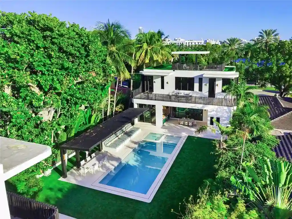 Front exterior of 2053 N Bay Rd Miami Beach modern waterfront estate with sleek architecture and tropical landscaping