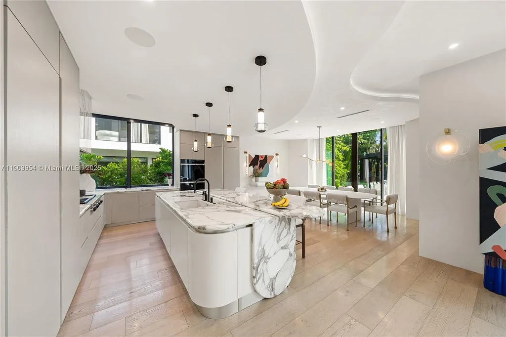 Front exterior of 2053 N Bay Rd Miami Beach modern waterfront estate with sleek architecture and tropical landscaping