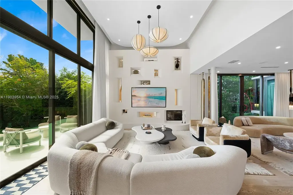 Front exterior of 2053 N Bay Rd Miami Beach modern waterfront estate with sleek architecture and tropical landscaping