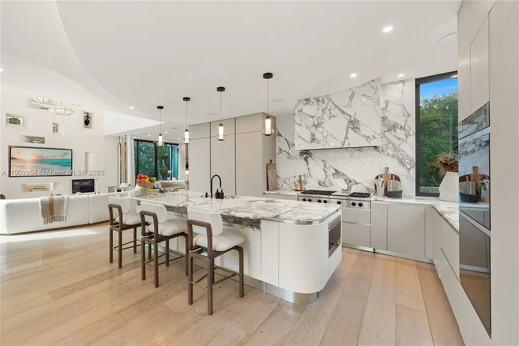 Front exterior of 2053 N Bay Rd Miami Beach modern waterfront estate with sleek architecture and tropical landscaping