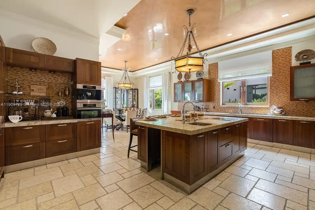 Luxury waterfront estate at 210 Palm Ave Miami Beach with infinity pool, private dock, modern finishes, and panoramic bay views