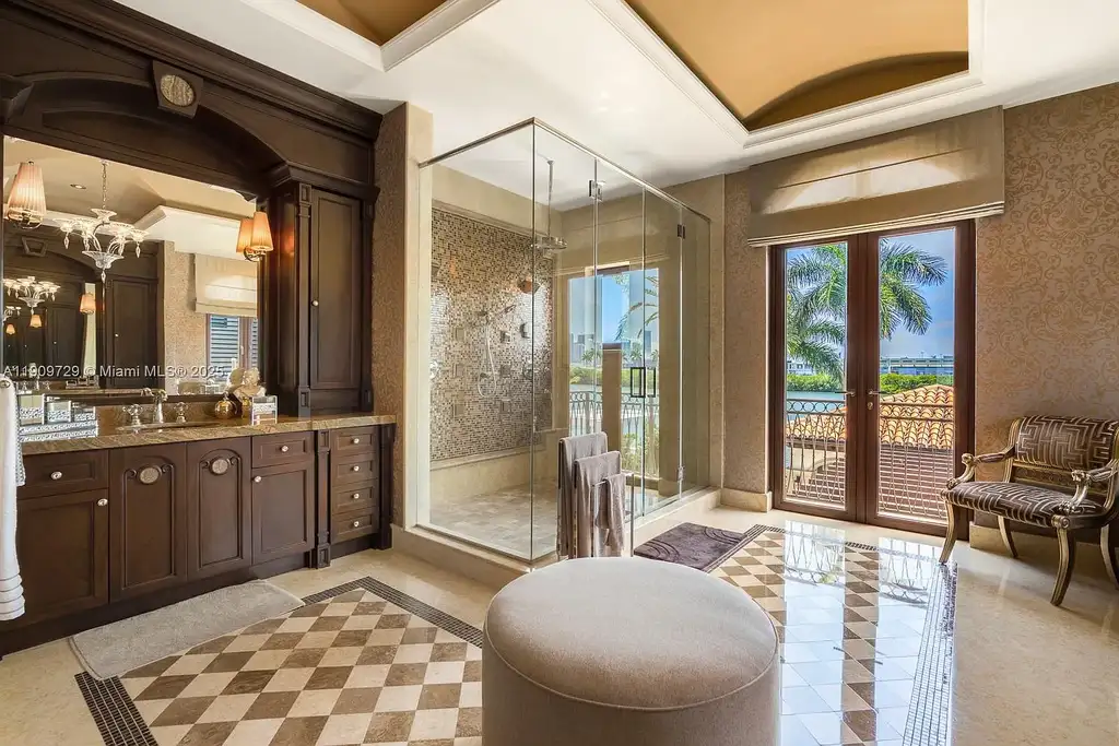 Luxury waterfront estate at 210 Palm Ave Miami Beach with infinity pool, private dock, modern finishes, and panoramic bay views