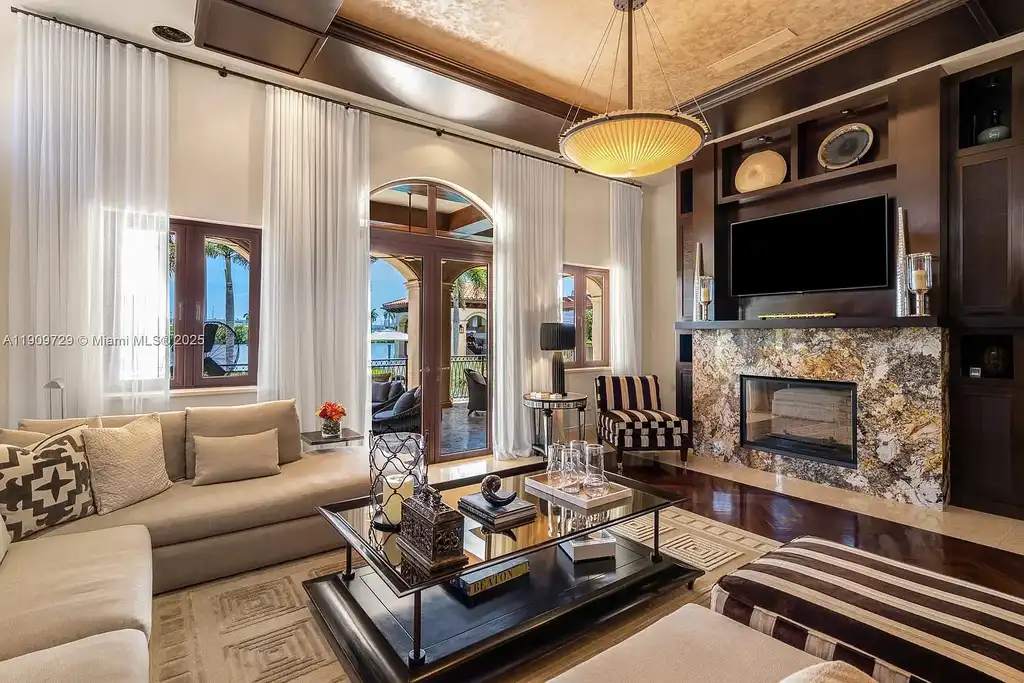 Luxury waterfront estate at 210 Palm Ave Miami Beach with infinity pool, private dock, modern finishes, and panoramic bay views