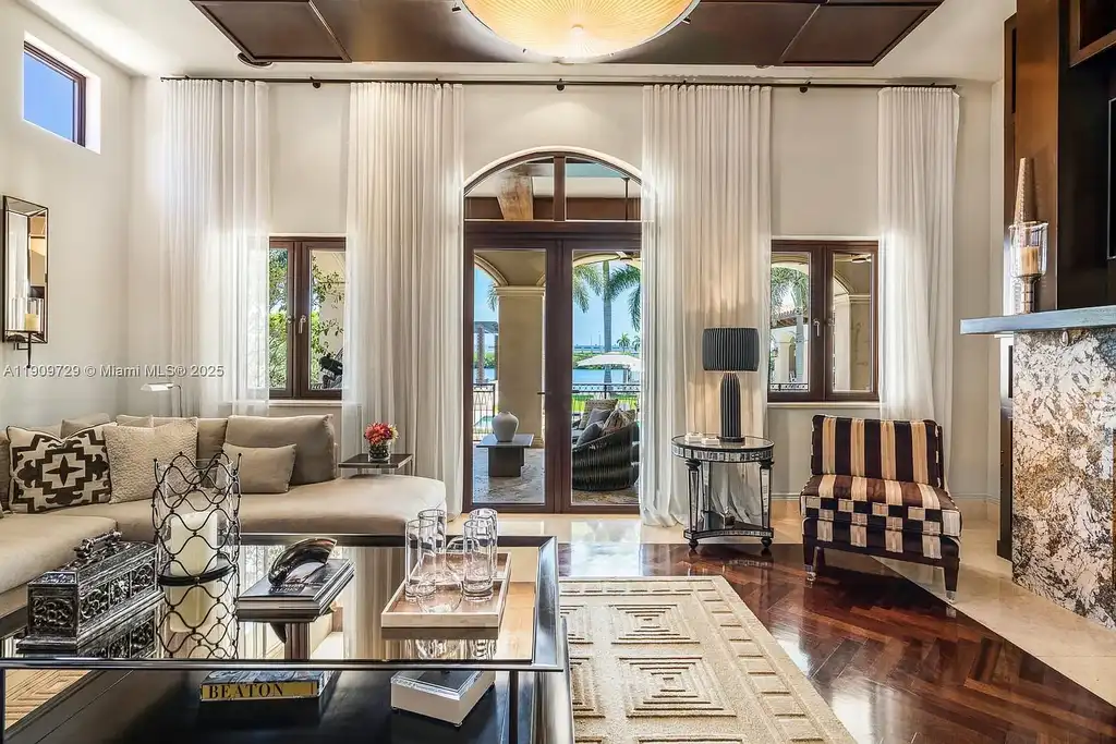 Luxury waterfront estate at 210 Palm Ave Miami Beach with infinity pool, private dock, modern finishes, and panoramic bay views