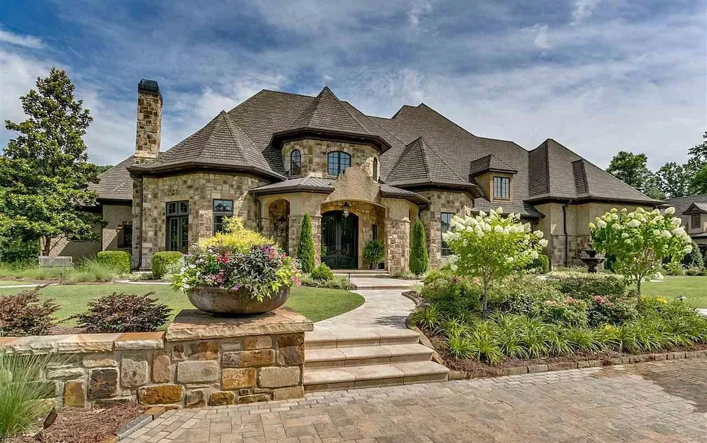 Front exterior of luxury estate at 2470 Cahaba Valley Rd, Indian Springs, Alabama, featuring stone façade, manicured landscaping, and grand architectural design, featured in Luxury Houses Magazine.