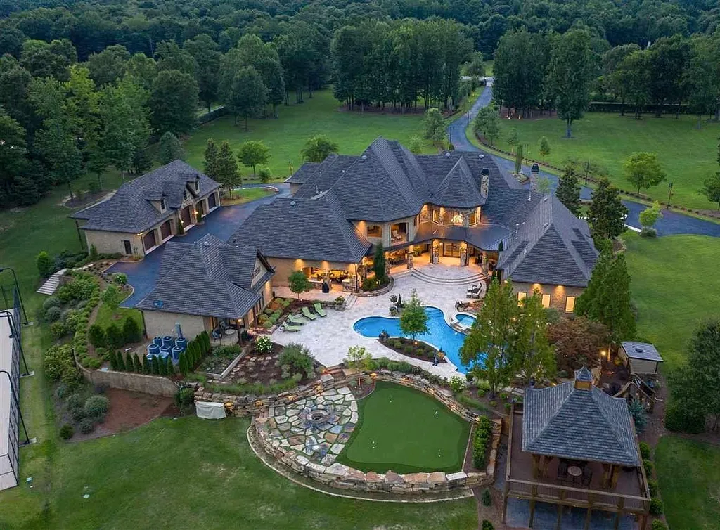 Aerial view of the luxury estate at 2470 Cahaba Valley Rd in Indian Springs, Alabama — featuring a grand transitional-style home surrounded by lush 41-acre grounds, a heated pool, putting green, and guest pavilion, as showcased in Luxury Houses Magazine.