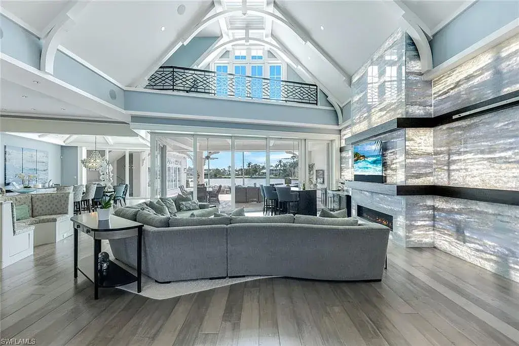 Bayfront luxury residence at 350 Spring Line DR in Naples featuring pool, spa, travertine lanai, and waterfront deck with boat lift.