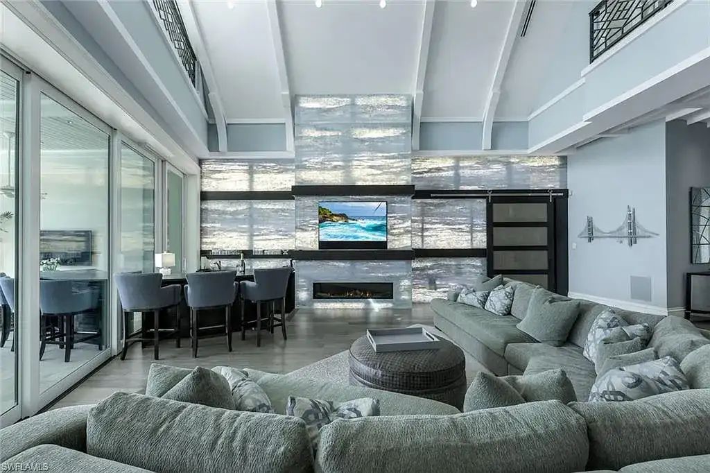 Bayfront luxury residence at 350 Spring Line DR in Naples featuring pool, spa, travertine lanai, and waterfront deck with boat lift.