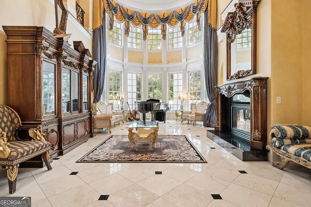 Close-up view of the two-story Piano Salon's curved floor-to-ceiling windows, marble floor, and neoclassical furniture with a grand piano.