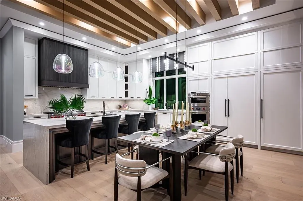 405 NEAPOLITAN WAY Naples FL luxury waterfront home featuring 5 bedrooms, 7 bathrooms, resort-style pool, outdoor kitchen, and panoramic bay views.