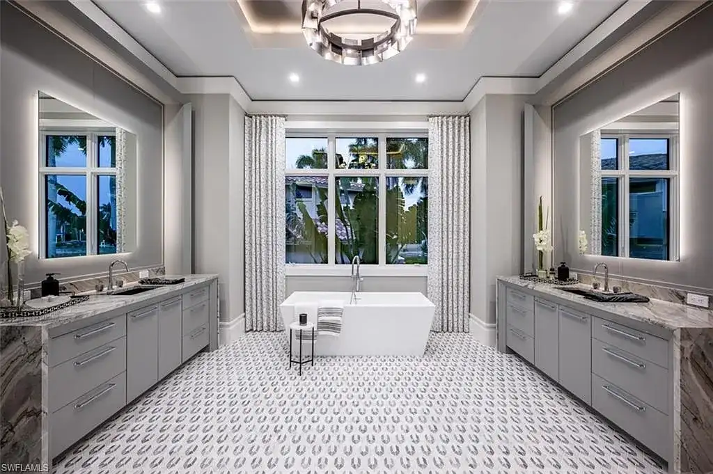 405 NEAPOLITAN WAY Naples FL luxury waterfront home featuring 5 bedrooms, 7 bathrooms, resort-style pool, outdoor kitchen, and panoramic bay views.