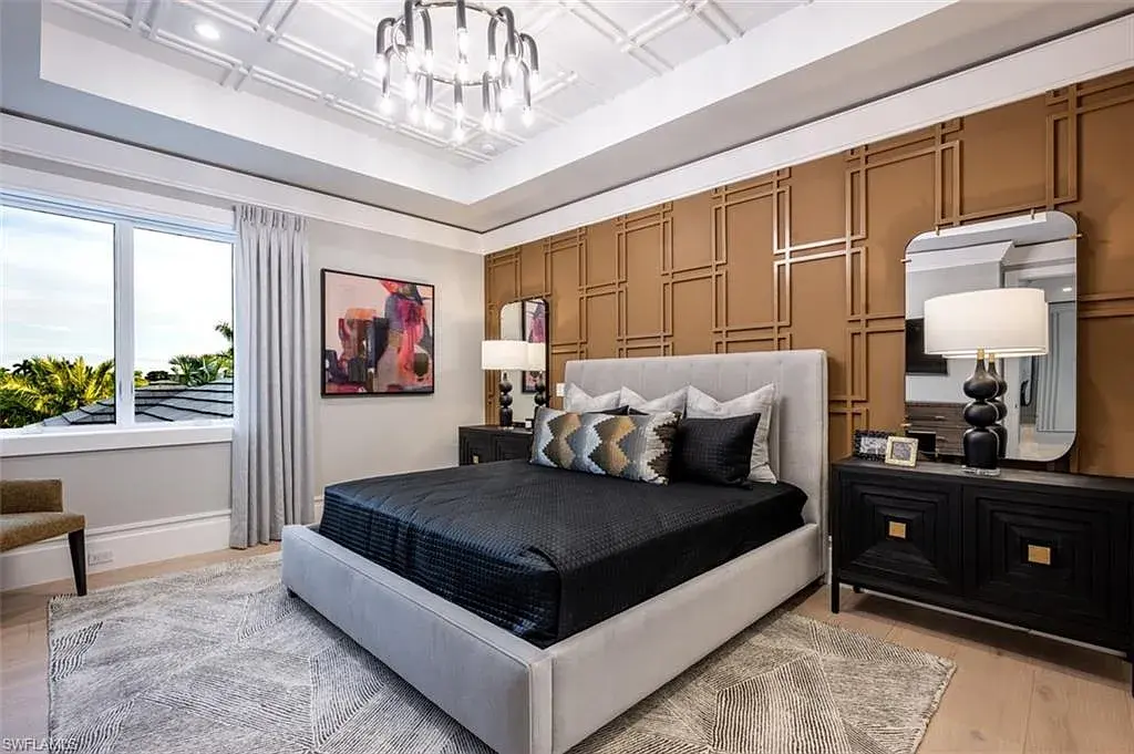 405 NEAPOLITAN WAY Naples FL luxury waterfront home featuring 5 bedrooms, 7 bathrooms, resort-style pool, outdoor kitchen, and panoramic bay views.