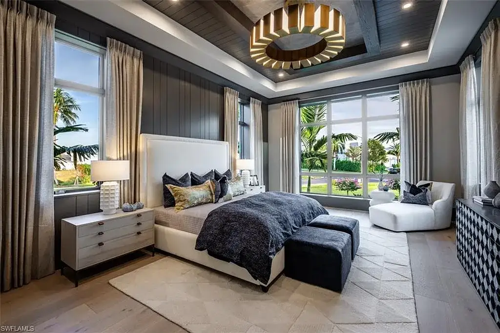 405 NEAPOLITAN WAY Naples FL luxury waterfront home featuring 5 bedrooms, 7 bathrooms, resort-style pool, outdoor kitchen, and panoramic bay views.