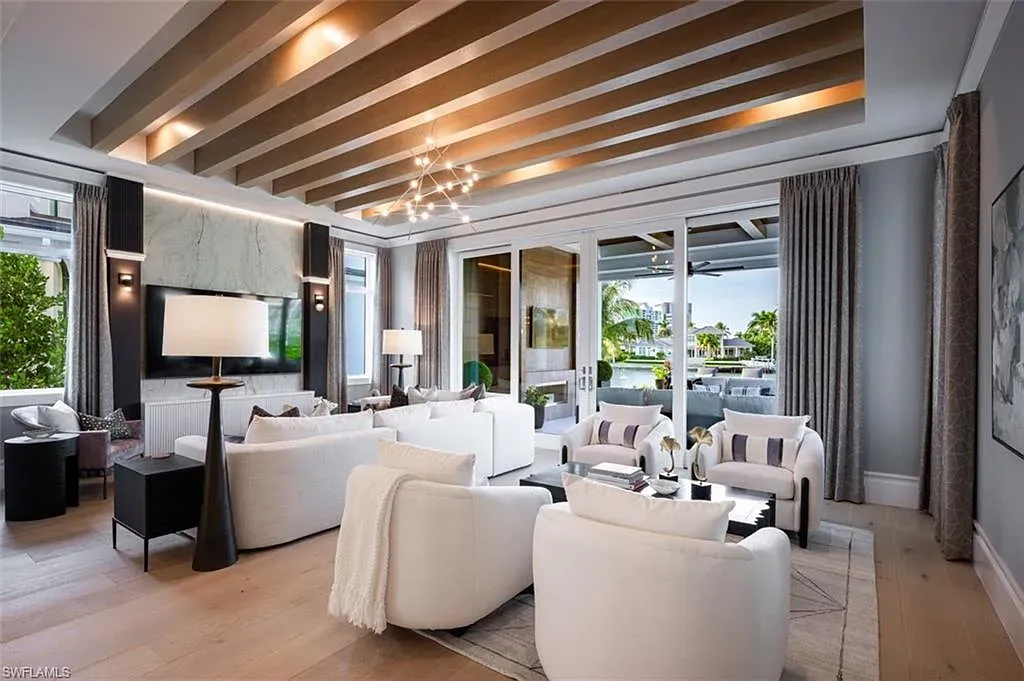 405 NEAPOLITAN WAY Naples FL luxury waterfront home featuring 5 bedrooms, 7 bathrooms, resort-style pool, outdoor kitchen, and panoramic bay views.