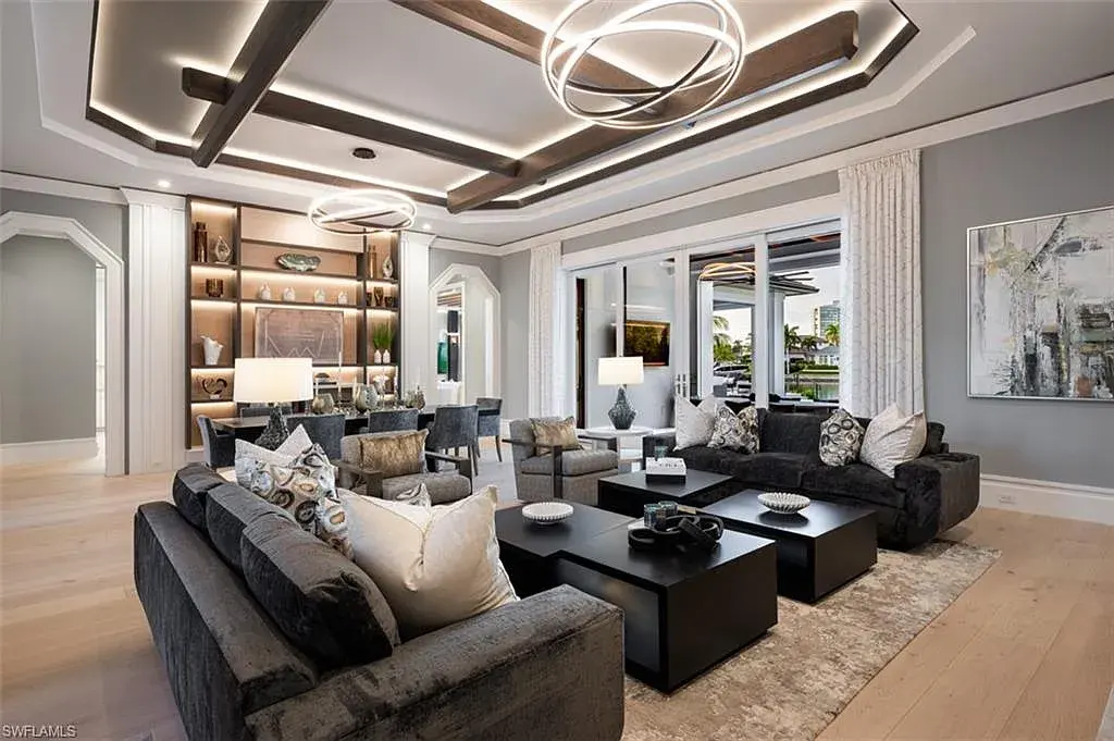 405 NEAPOLITAN WAY Naples FL luxury waterfront home featuring 5 bedrooms, 7 bathrooms, resort-style pool, outdoor kitchen, and panoramic bay views.