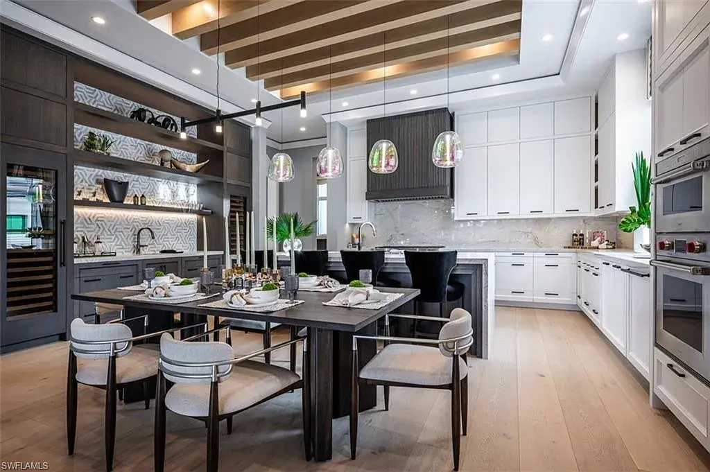 405 NEAPOLITAN WAY Naples FL luxury waterfront home featuring 5 bedrooms, 7 bathrooms, resort-style pool, outdoor kitchen, and panoramic bay views.