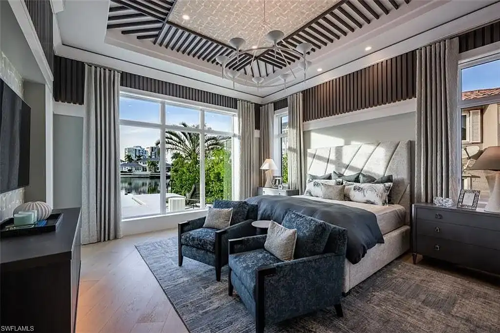 405 NEAPOLITAN WAY Naples FL luxury waterfront home featuring 5 bedrooms, 7 bathrooms, resort-style pool, outdoor kitchen, and panoramic bay views.