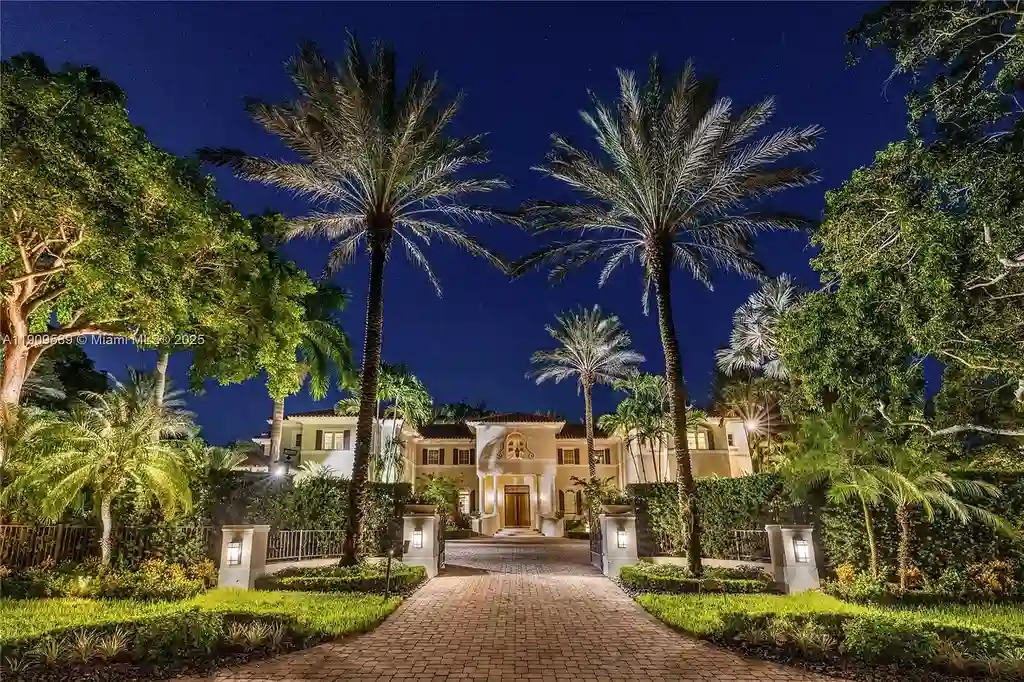 A Spectacular $18.5 Million Waterfront Estate Offering Elevated Luxury Living in Coral Gables 6 Front view of 5250 Snapper Creek Rd in Coral Gables showing the gated entrance, lush landscaping, and Mediterranean-inspired architecture.