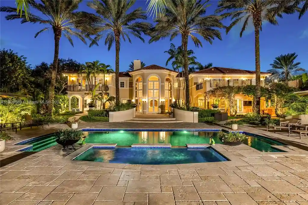 A Spectacular $18.5 Million Waterfront Estate Offering Elevated Luxury Living in Coral Gables 17 Front view of 5250 Snapper Creek Rd in Coral Gables showing the gated entrance, lush landscaping, and Mediterranean-inspired architecture.