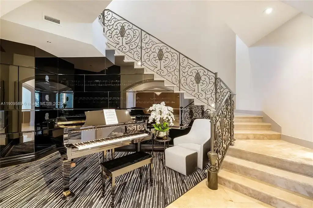 A Spectacular $18.5 Million Waterfront Estate Offering Elevated Luxury Living in Coral Gables 8 Front view of 5250 Snapper Creek Rd in Coral Gables showing the gated entrance, lush landscaping, and Mediterranean-inspired architecture.