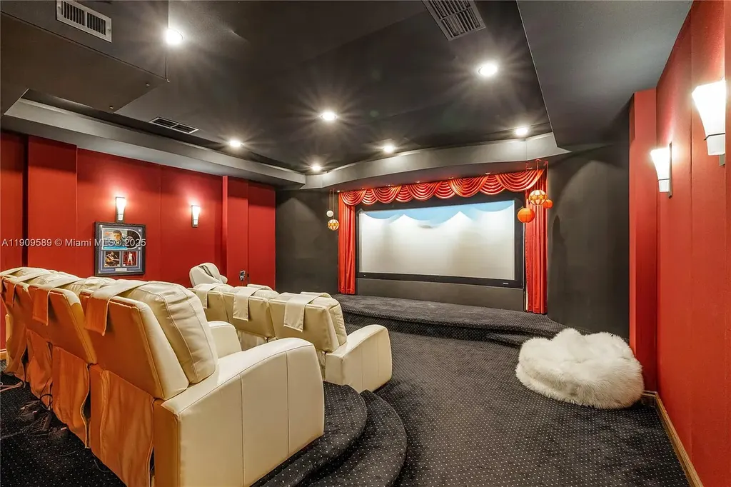 A Spectacular $18.5 Million Waterfront Estate Offering Elevated Luxury Living in Coral Gables 16 Front view of 5250 Snapper Creek Rd in Coral Gables showing the gated entrance, lush landscaping, and Mediterranean-inspired architecture.