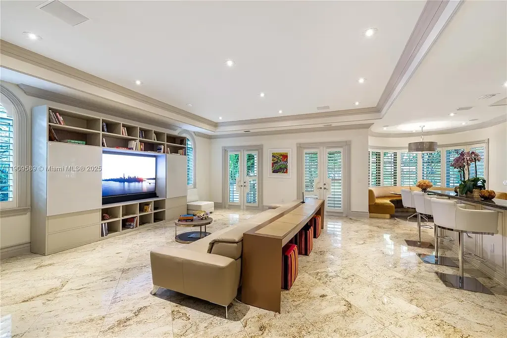 A Spectacular $18.5 Million Waterfront Estate Offering Elevated Luxury Living in Coral Gables 9 Front view of 5250 Snapper Creek Rd in Coral Gables showing the gated entrance, lush landscaping, and Mediterranean-inspired architecture.