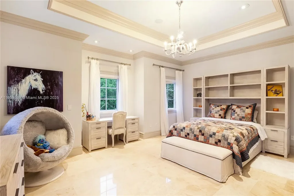 A Spectacular $18.5 Million Waterfront Estate Offering Elevated Luxury Living in Coral Gables 14 Front view of 5250 Snapper Creek Rd in Coral Gables showing the gated entrance, lush landscaping, and Mediterranean-inspired architecture.