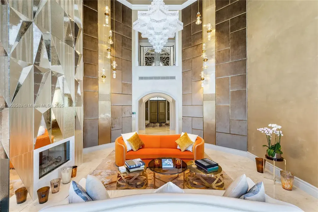 A Spectacular $18.5 Million Waterfront Estate Offering Elevated Luxury Living in Coral Gables 7 Front view of 5250 Snapper Creek Rd in Coral Gables showing the gated entrance, lush landscaping, and Mediterranean-inspired architecture.