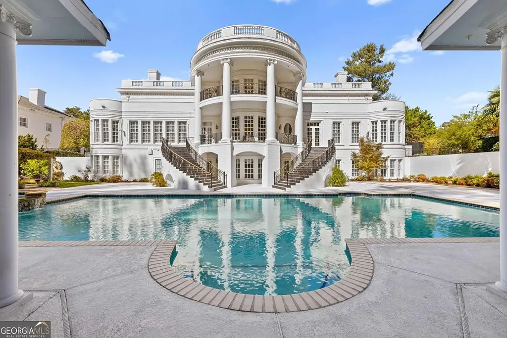 Rear elevation of the $35M Atlanta White House mansion showcasing the grand semicircular portico, dual staircases, and oversized pool and spa area.