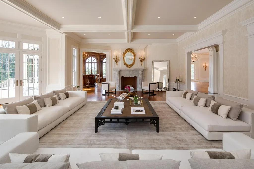 Step Inside One of America’s Most Extraordinary Modern Estates in Alpine 5 Elegant grand living room at 1 Frick Drive Alpine New Jersey featuring symmetrical sofas marble fireplace coffered ceilings and expansive natural light.