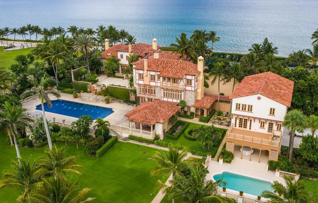 The 5 Biggest Houses in Florida and Their Insane Amenities (2025 Ultimate List) 3 Oceanfront view of a large Mediterranean-style compound in Manalapan, Florida, featuring two pools and lush green gardens leading to the beach.
