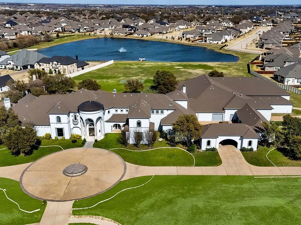 The 5 Largest Houses in Texas Ranked by Verified Square Footage (2025) 4 Aerial view of The Prosper Mansion at 1400 Copper Point Drive, Prosper, TX, showing the 29,122 sq ft compound, large circular drive, and surrounding lake in North Dallas's luxury market.
