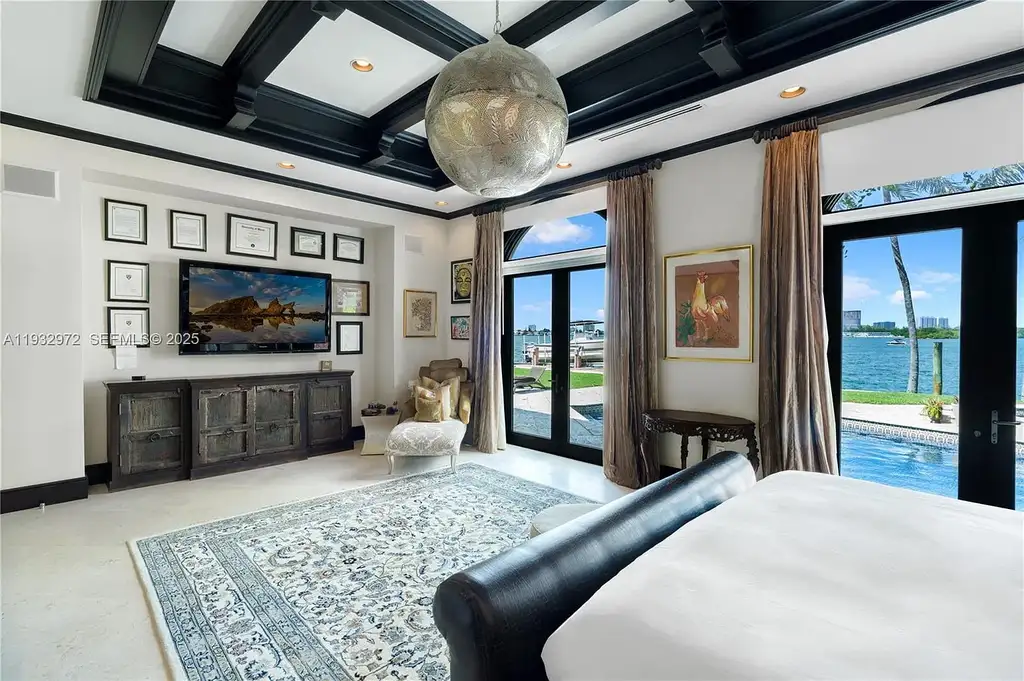 $34.5 Million Waterfront Estate Redefines Quiet Luxury in Bay Harbor Islands 14 Waterfront view of 10330 W Broadview Dr, a luxury home in Bay Harbor Islands for sale, featuring a Mediterranean-style design with open bay and Intracoastal views.