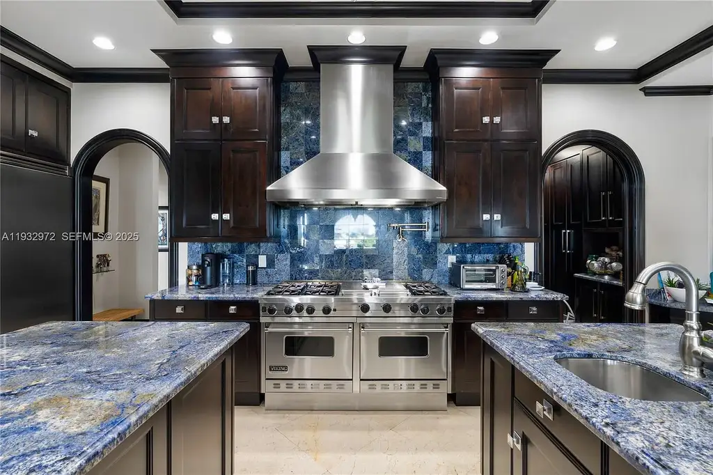 $34.5 Million Waterfront Estate Redefines Quiet Luxury in Bay Harbor Islands 9 Waterfront view of 10330 W Broadview Dr, a luxury home in Bay Harbor Islands for sale, featuring a Mediterranean-style design with open bay and Intracoastal views.